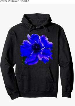 **Blue Poppy Hoodie** A striking blue poppy flower printed on a cozy black hoodie. Bright, bold, and artistic — a floral design that celebrates beauty in every season.